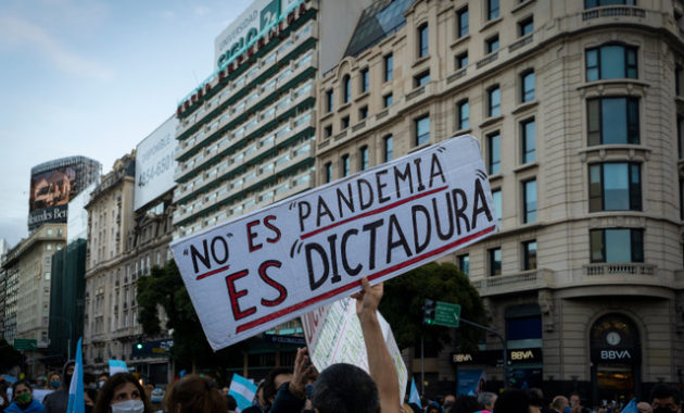 Buenos Aires, Argentina - 9 july 2020: Anti lockdown protesters march in defiance of the government.  The poster says "it is not a pandemic it is a dictatorship"